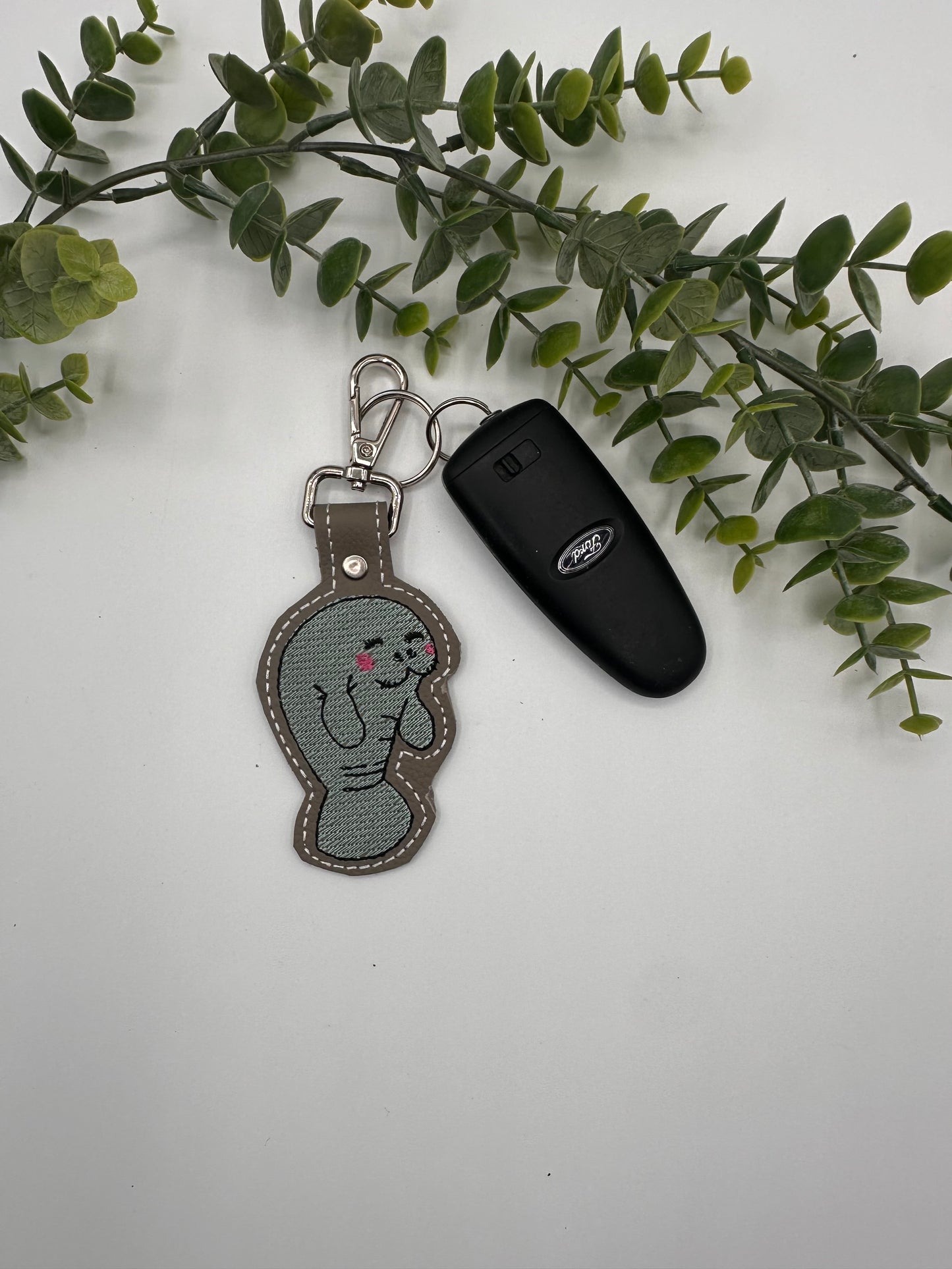 Manatee embroidered leather keychain